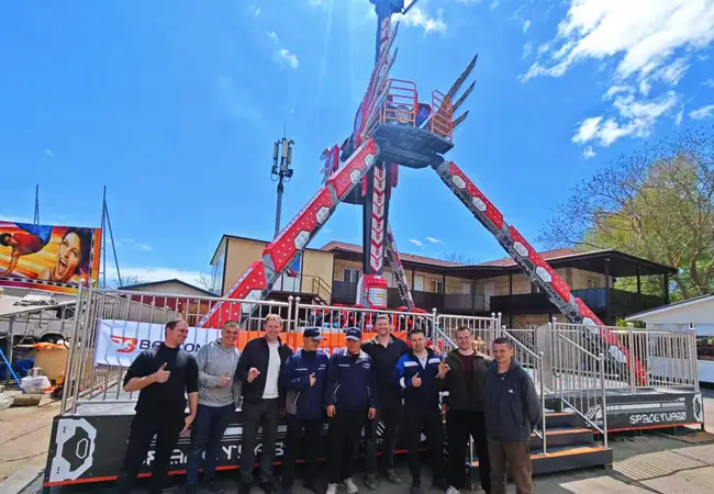 The Beston Rides engineers Standing in Front of the Completed Pendulum Ride, Signaling Successful Project Delivery.